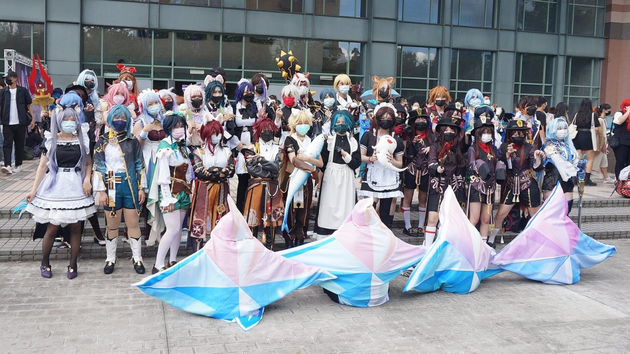 Genshin Impact cosplayers at a Taiwan fan convention, one dressed as a Primogem