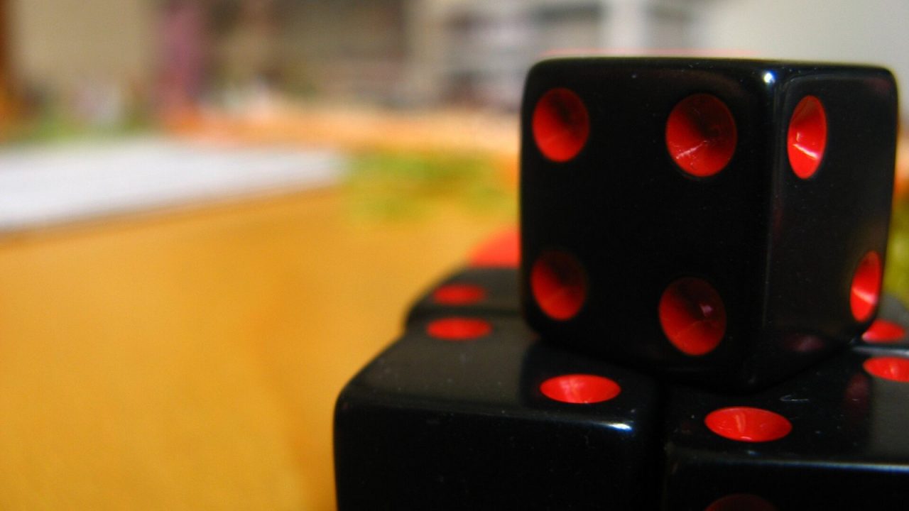 A pile of red and white six-sided dice from a board game