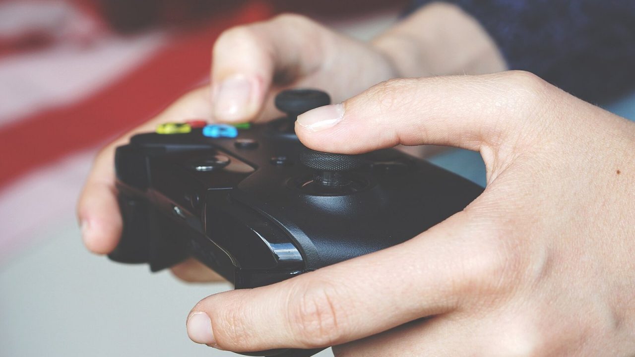 Close-up of a person holding a video game controller